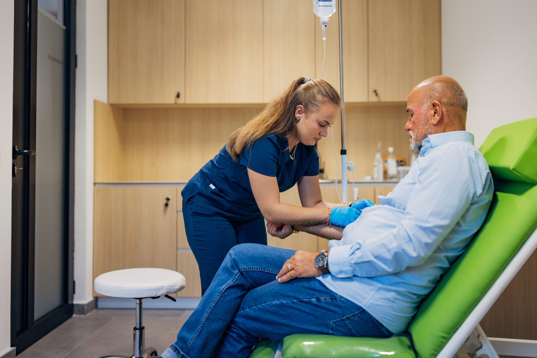 An elderly man getting a blood draw.